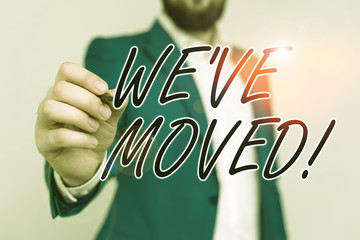 Word writing text We Ve Moved. Business photo showcasing having strong feelings sadness or sympathy has said or done Businessman with pointing finger in front of him