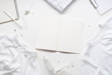 White monochromatic flatlay on white background with copy space at the center. Clothes,...