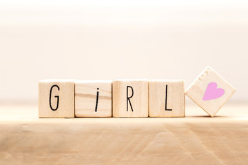 Wooden cubes with a hashtag and the word girl, social media concept