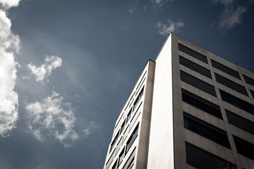 Generic high rise building towards blue sky with clouds