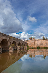 View of the Roman bridge of Merida with its reflection on the Guadiana river. Merida. Spain.The...