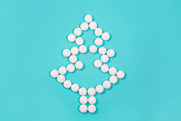 Elegant Christmas tree of white pills on blue background. Christmas and New year concept. Holiday for health care, medical and pharmacy chain. Creative minimalist medicines. Copy space