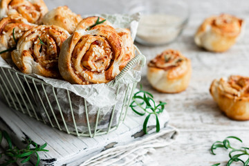 Unsweetened snails and puff pastry with bacon, sesame seeds and rosemary.