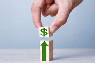 Wood block cubic stacking up with green arrow up and green Arrow Blue Tone. Business growth success...