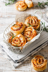 Unsweetened snails and puff pastry with bacon, sesame seeds and rosemary.