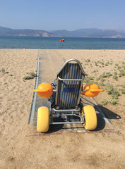 Beach wheel chair for disabled people in Nafplion, Greece. The chair enables disabled persons to...
