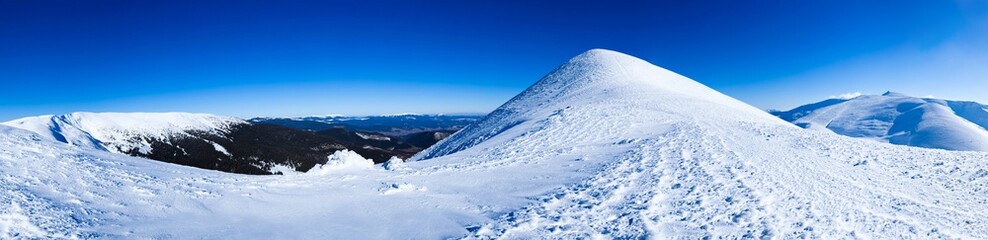 Fototapeta na wymiar Panoramic view of mountains covered with snow