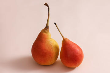 Isolated pears shot on a pastel pink background.