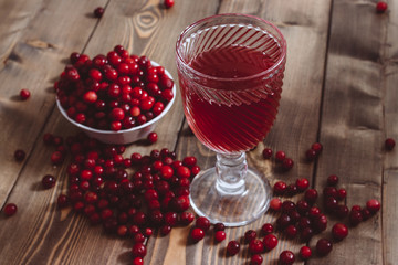 red vitamin drink. cranberry juice and fresh cranberries on the table