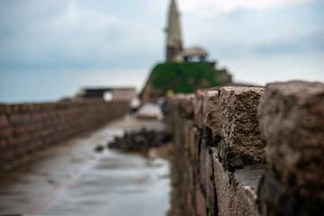 Stones of the wall on the ancient Chinese bridge. Old architecture building and cloudy sky on the background. Panorama 