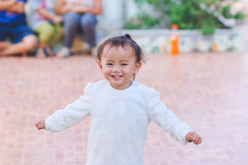 Little happy adorable child in white sweater, Energetic kid with big beautiful smile