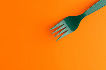 Plastic Fork Isolated On Orange Background, Green Plastic Fork