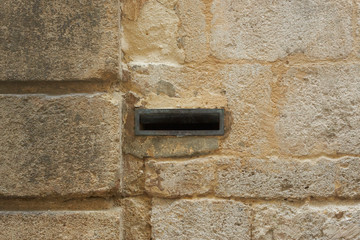 old brick wall with a mail slot