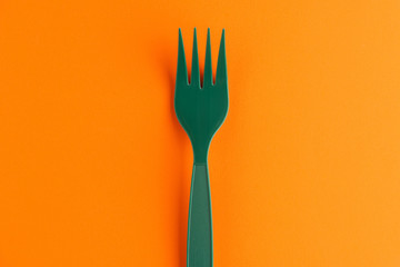 Plastic Fork Isolated On Orange Background, Green Plastic Fork