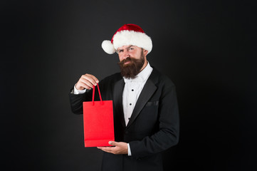 Serious Christmas shopping. Bearded man hold shopping bag. Director got ready for christmas and new year. Holiday preparation. Christmas sale. Merry Christmas. Happy new year, copy space