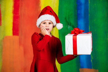 Ready for holiday. everyone will get a present. small girl in santa costume. kid with purchase. christmas shopping and sale. xmas party surprise. winter holiday mood. surprise for new year holiday