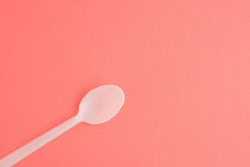 Plastic Spoon Isolated On Pink Background, White Plastic Spoon
