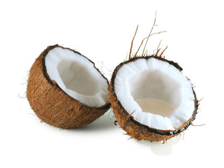Halved coconut with flowing drops of coconut water isolated on a white background 
