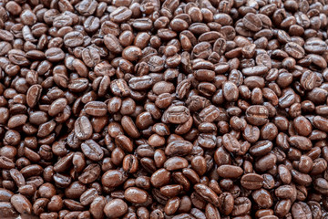 brown and black roasted arabica coffee baens. mashed roasted coffee beans is ingredients of espresso, cappuccino, latte, mocha, americano. coffee is favorite beverage at morning and afternoon break