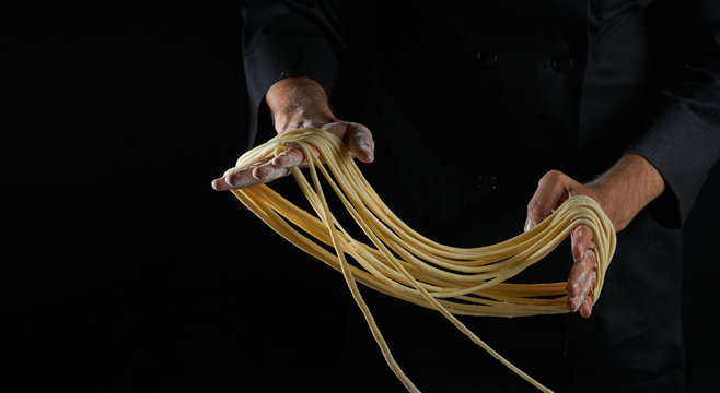 Chef hands making fresh noodles