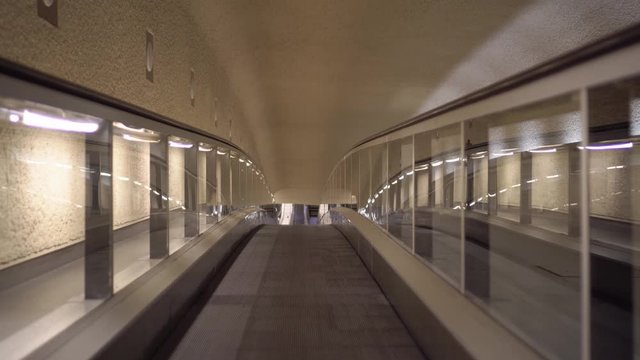 Smooth forward movement on a horizontal escalator, in the lobby of the international airport in Paris. Transfer between terminals. Nobody. Ultra HD footage
