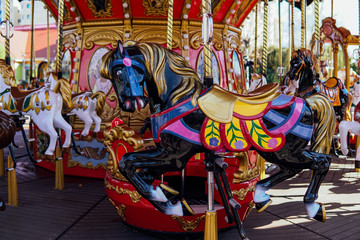 Fototapeta na wymiar Carousel for children with horses attractions in the Park