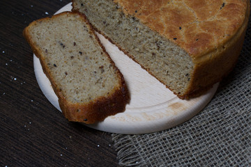 Freshly baked bread. A loaf of bread is cut and lies on a cutting board.