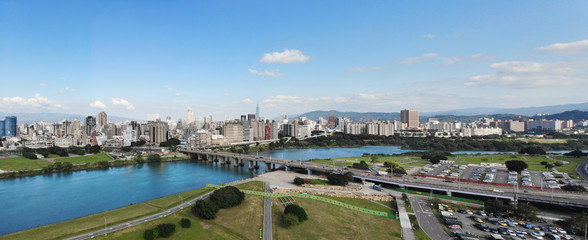 Aerial photography of riverside park in Taipei, Taiwan, city under blue sky and white clouds