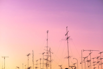 Fototapeta premium Beautiful view silhouette of television aerials(antennas) with the background at sunset time.