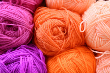 background of rows skeins of fluffy wool yarn for knitting different bright colors