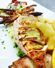 fresh squid with potato fries at a greek tavern - mediterranean seafood