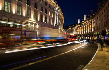 Fototapeta na wymiar night scene of London city United Kingdom with the moving red buses and cars - long exposure photography