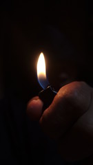 hand with flame on black background