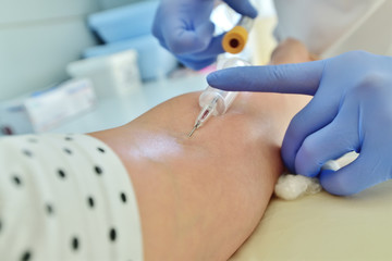 Doctor takes blood from a vein for analysis