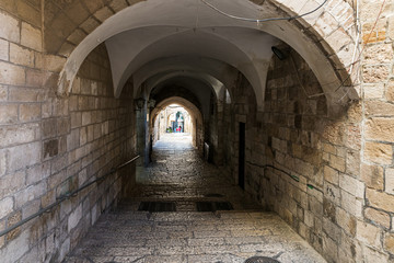 Fototapeta na wymiar Narrow passage between houses in the old city of Jerusalem near to the gate Jaffa Gate in the Old City in Jerusalem, Israel