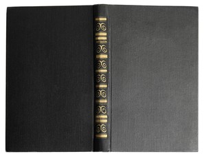 Open old book with vintage black cover isolated on white, top view