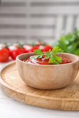 Delicious fresh tomato sauce with parsley on table