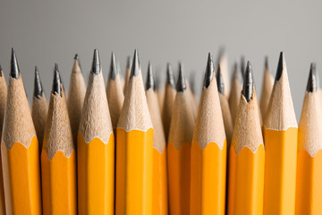 Sharp graphite pencils on grey background, closeup - Powered by Adobe