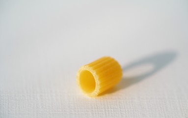 Close up view on dry Italian ditaloni pasta on white background