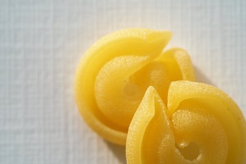 Fototapeta na wymiar Top view on Italian messicani pasta shapes on white background