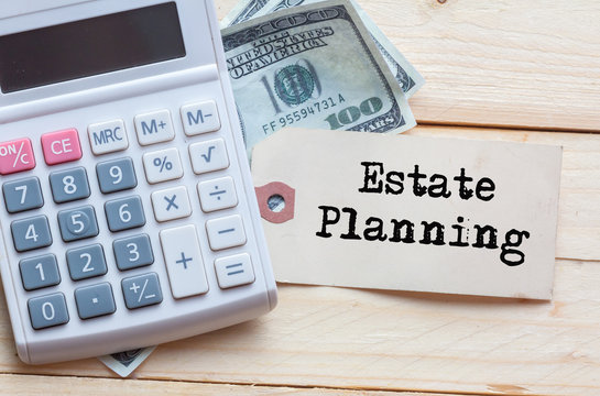 Estate Planning Words on tag with dollar note and calculator on wood backgroud,Finance Concept