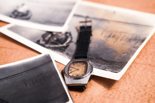 Old watch and photos, family ancestry, memories concept 