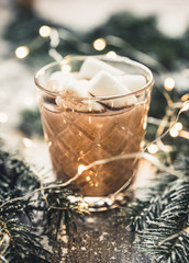 Glass of hot chocolate with christmas decorations on the rustic background. Selective focus. Shallow depth of field.