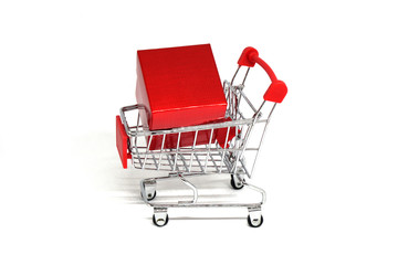 Shopping Cart and red presents gift box isolated white background - Shopping stores to buy xmas goods concept 