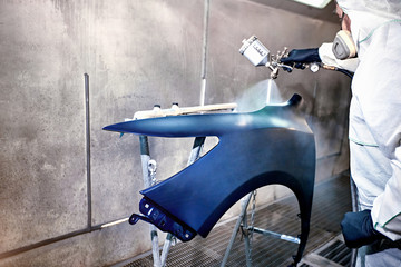 Preparation and painting of car parts after an accident.