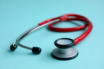 Red doctor stethoscope on blue modern background