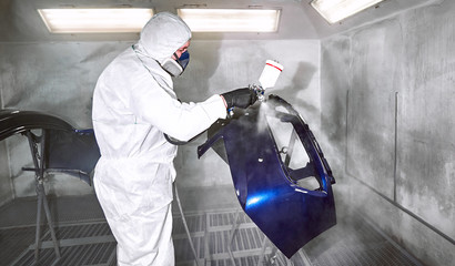 Preparation and painting of car parts after an accident.