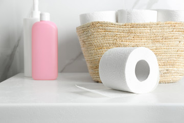 Toilet paper rolls on countertop in bathroom
