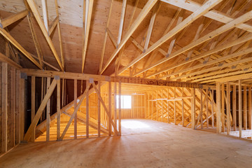 Interior of attic room with under reconstruction installing wooden frame for improvement