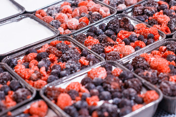 Making summer cakes with fresh berries, raspberries and blackberries with cherries and black currants. Delicious dessert. Food industry